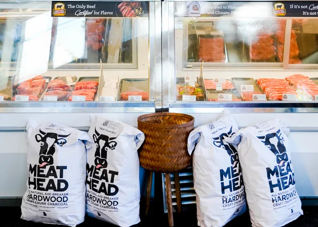 The butcher case at Frazie's, filled with steaks, chops and fresh fish, with sacks of hardwood charcoal below it.